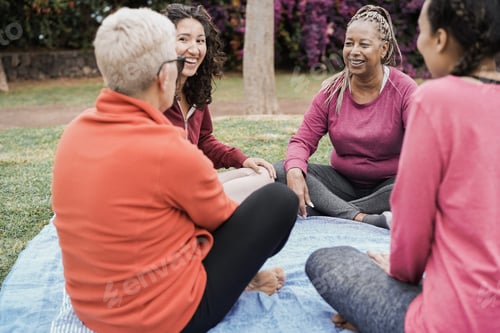Preview: Happy Multi Generational Women Having Fun Together Sitting Outdoors At City Park - Focus On African