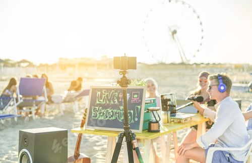 Preview: Group Of Young People Making A Video Live Streaming From Beach Party At Sunset - Man Vlogger Using