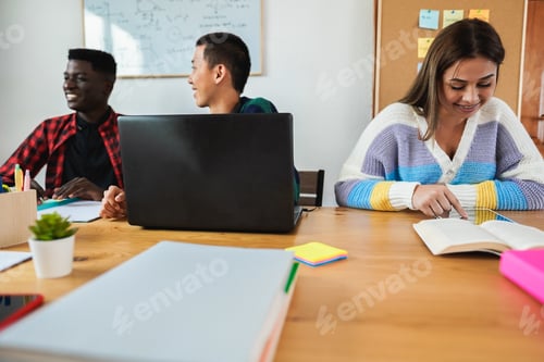 Preview: Multiracial Students Reading Books And Using Laptop While Studying Together Inside Library - Soft