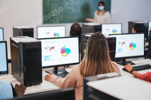Preview: Multiracial Students Using Computers During College Class Wearing Safety Masks - Focus On Center