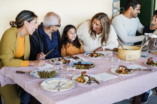 Preview: Happy Latin Family Having Fun Eating Together At Home - Focus On Grandmother Face