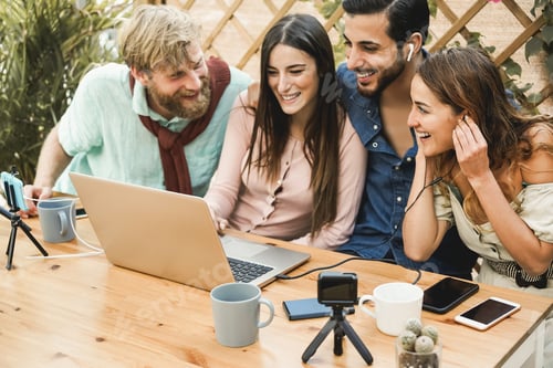 Preview: Young People Streaming Online Using Laptop Computer And Mobile Phone Camera Outdoor At Restaurant