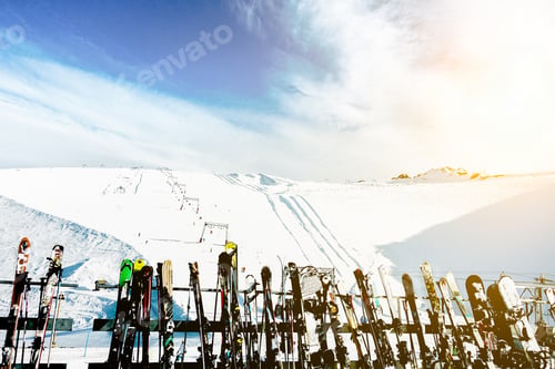 Preview: Skies And Snowboards In Deux Alps Chalet Mountain Resort With Ski Slope In Background - Panoramic