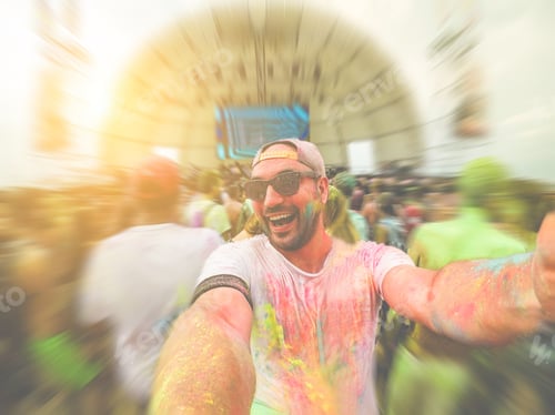 Preview: Enthusiastic Man Celebrating Holi with Friends at Festival