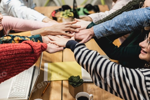 Preview: Happy Young Teamwork Celebrating Together Stacking Hands Inside Startup Office - Focus On Hands