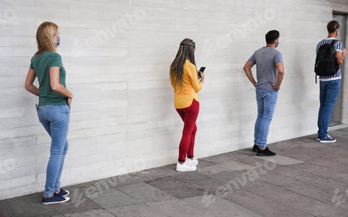 Preview: Group Of Young People Waiting For Going Inside A Shop Market While Keeping Social Distance In A