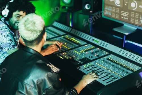 Preview: Musician And Sound Engineer Mixing New Album Inside Boutique Recording Studio - Soft Focus On Right