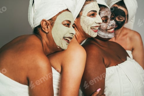 Preview: Multigenerational Women Having Fun Wearing Face Beauty Masks For Skin Care Therapy - Focus On