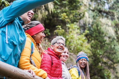 Preview: Multiracial Women Having Fun Exploring Nature On Trekking Day In Mountain Forest - Focus On Center