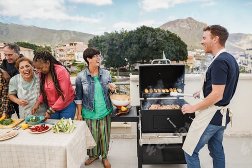 Preview: Happy Friends Cooking Corn And Chicken At Barbecue Rooftop Dinner - Multigenerational People Having
