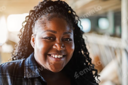Preview: Portrait Of Young African Farmer Woman Working Inside Cowshed - Focus On Face