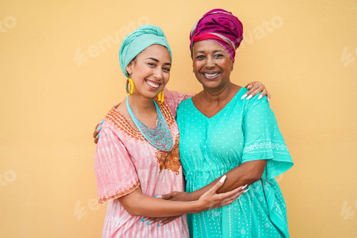Preview: Happy Mother And Daughter With Traditional African Dresses Smiling On Camera - Focus On Faces