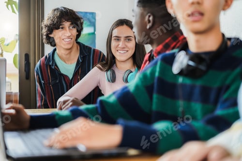 Preview: Multiracial Students Using Laptop Computers While Studying Together At School - Focus On Girl Face