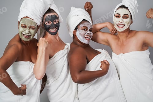 Preview: Multigenerational Women Having Fun Wearing Skin Care Beauty Masks - Main Focus On African Girl Face