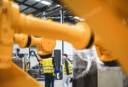 Preview: Engineers Working Inside Robotic Factory - Industrial And Technology Concept - Focus On Young Man