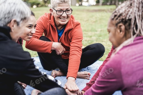 Preview: Multiracial People Stacking Hands Outdoor At City Park - Focus On Center Senior Woman Face