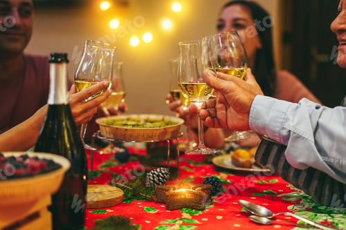 Preview: Happy Family Cheering With Champagne While Eating Christmas Holiday Dinner Together - Focus On