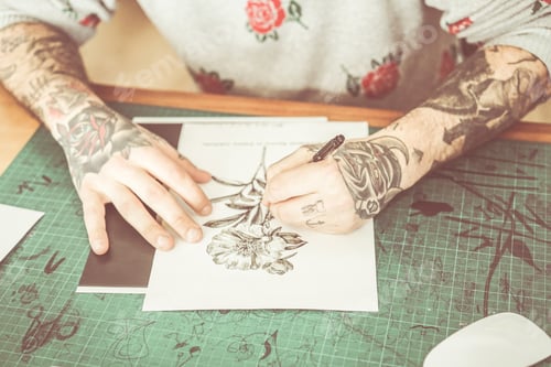 Preview: Tattoo Artist Drawing New Flower Illustration Inside Ink Studio - Hipster Tattoer At Work - New