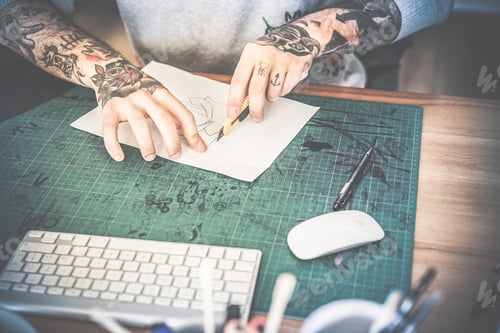 Preview: Tattoo Artist Cutting Paper Flower Illustration Inside Ink Studio - Hipster Tattoer At Work - New