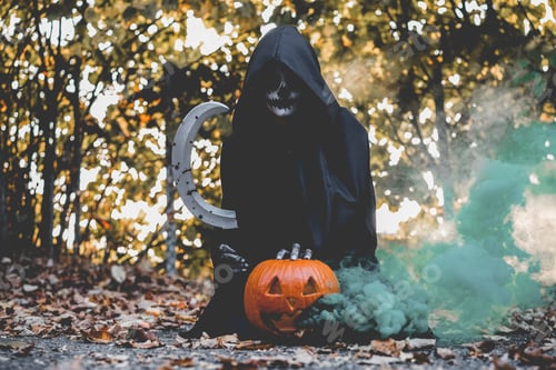 Preview: Girl With Halloween Make Up, Holding A Sickle With Blood And A Pumpkin With A Smoke Bomb Inside