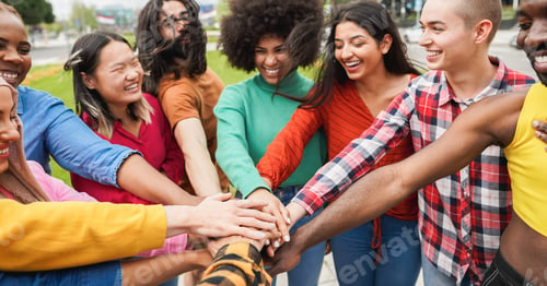 Vista previa: Young Multiethnic People Having Fun Stacking Hands Outdoor - Focus On Hands