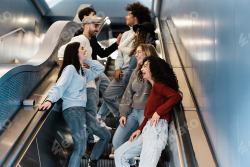 Preview: Happy Group Of Friends Having Fun Together On Subway Metro Stairs - Soft Focus On Bottom Right Girl