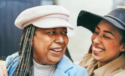 Preview: African Mother And Daughter Having Fun Together During Winter Time Outdoor - Focus On Senior Woman