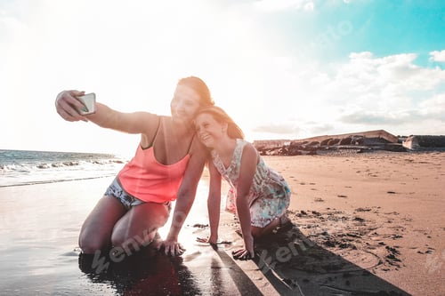 Preview: Happy Mother And Daughter Taking Selfie Photo With Smartphone On The Beach - Mother Having Fun With