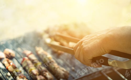 Preview: Young Man Cooking Meat On Barbecue - Chef Putting Some Meat Skewers On Grill In Garden Outdoor