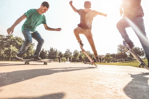 Preview: Skaters Jumping With Skateboard In City Skate Park - Young Guys Performing Tricks And Skills At