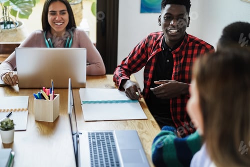 Preview: Multiracial Students Using Laptop Computers While Studying Together At School - Focus On African