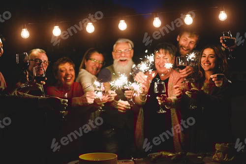 Preview: Happy Family And Friends Celebrating With Sparkler Fireworks At Home Dinner - Different Age Of