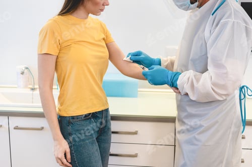 Preview: Doctor Giving Patient A Vaccine For Coronavirus Disease - Medical And Healthcare Concept - Focus On
