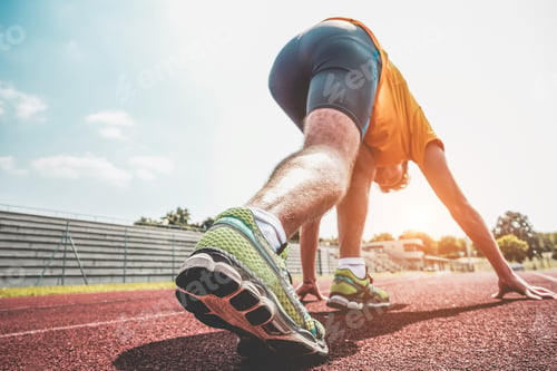 Preview: Athlete Training On Athletic Running Track - Young Runner Man Ready To Sprint Outdoor In Sport Camp