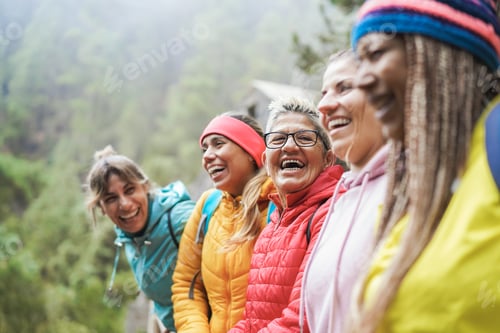 Preview: Multiracial Women Having Fun Exploring Nature On Trekking Day - Focus On Center Senior Face