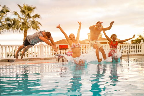 Preview: Group Of Happy Friends Jumping Inside Swimming Pool - Young Crazy People Having Fun In Tropical