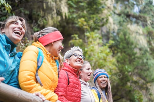 Preview: Multiracial Women Having Fun Exploring Nature On Trekking Day In Mountain Forest - Focus On Center