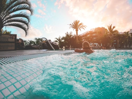 Preview: Young Woman Relaxing Inside Pool At Sunset Outdoor - Girl Enjoying Summer Vacation In A Tropical