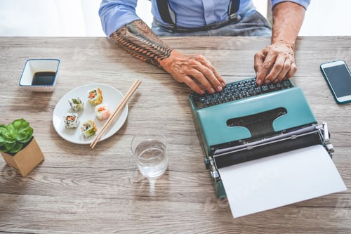 Preview: Trendy Tattoed Businessman Eating Sushi At Lunch Time While Working - Senior Entrepreneur Writing