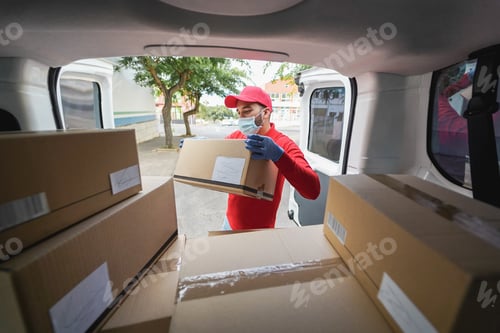 Preview: Delivery Man Wearing Protective Mask During Coronavirus Outbreak - Main Focus On Hand