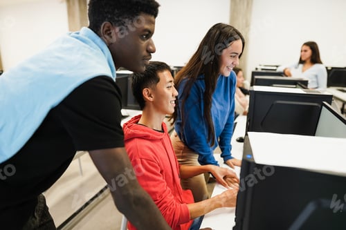 Preview: Multiracial Students Using Computers During Business Class At School - Focus On Asian Guy Face