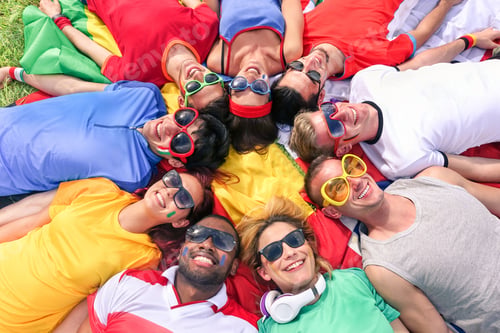 Preview: Group Of Mixed Race Friends Lying On Meadow - Young Multiracial Supporters Relaxing And Smiling All
