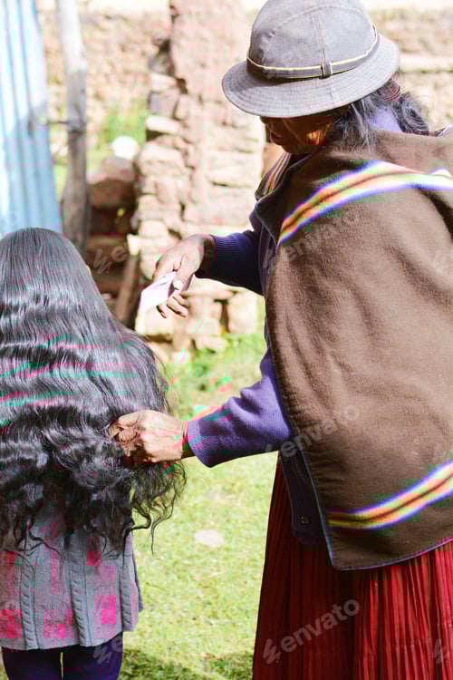 Preview: Native American Grandmother Combing Hair Of Her Granddaughter In The Countryside.
