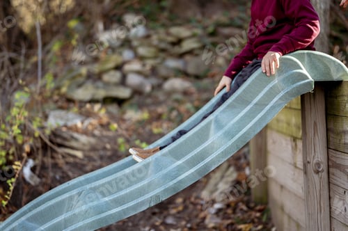 Preview: A Child Playing On The Slide On The Playground Of A Park