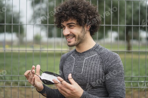Preview: A Smiling Energetic Spanish Guy Is About To Put On A Protective Mask