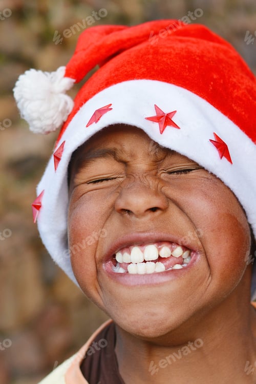 Preview: Happy Native American Boy Wearing Typical Red Santa Claus Hat.