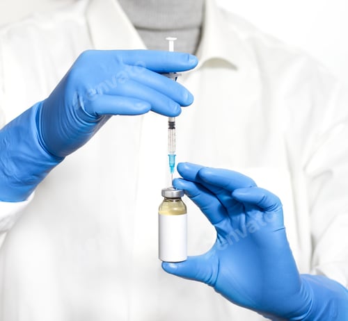 Preview: A Selective Focus Closeup Of A Pair Of Hands Wearing Gloves While Holding A Syringe And A Vaccine