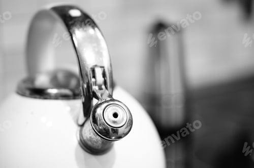 Preview: A Grey-Scale Shot Of A Kettle On The Stove In A Kitchen