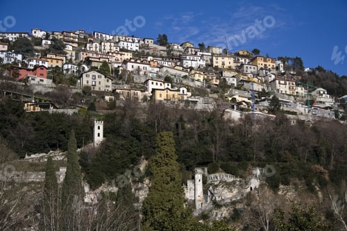 Preview: A Low Angle Shot Of Houses In The Mountain With A Blue Sky In The Background