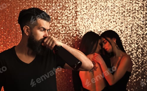 Preview: Hipster Drink Wine With Women On Glitter Background. Bearded Man With Bottle And Sexy Girls Hug